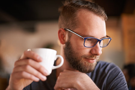 Thinking, man and glasses with coffee at cafe for morning start, past reflection and nostalgia as client. Male person, contemplation and beverage drink for customer experience, memory and hospitalityの写真素材
