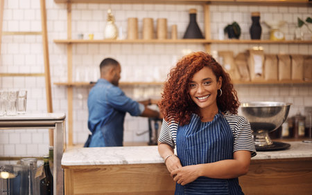 Woman, coffee shop and confident service in portrait, hospitality industry and welcome to bistro. Waitress, proud owner and professional manager in restaurant, entrepreneur and person in Jamaicaの写真素材