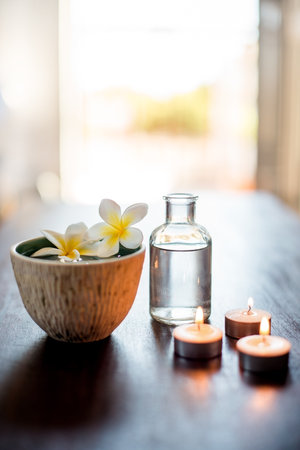 Spa, wellness and essential oil with flower in bowl for aromatherapy, pamper retreat and luxury treatment. Tranquil space, body care salon and empty room for stress relief, relaxation and hospitalityの写真素材