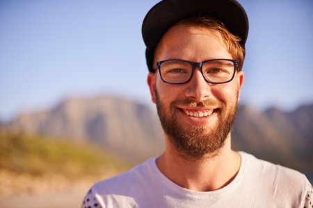 Portrait, outdoor and man with smile, travel and vacation with glasses, break and explore. Face, person and traveller with eyewear, summer holiday and getaway trip with happiness, nature and Baliの写真素材
