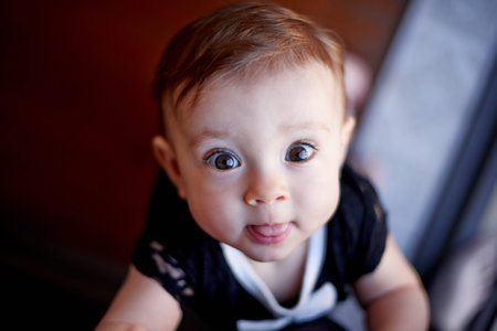 Development, portrait and tongue out with baby in home for curiosity, learning or progress as...