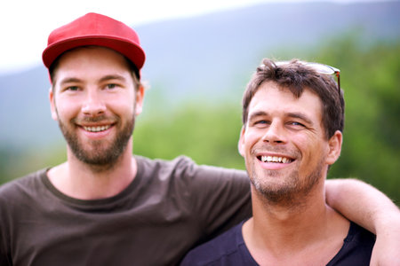 Outdoor, happy and portrait of friends for relax, bonding and reunion on vacation travel. People, smile and hug in nature with support, countryside holiday and excited for relationship developmentの写真素材