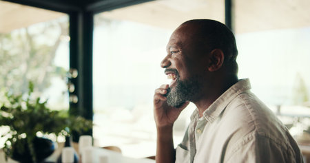 Mature, black man and laugh with phone call at house of discussion, funny joke and catch up in...