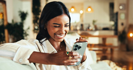Woman, phone and laughing with texting in home, chat and funny meme on sofa in living room. Girl,...