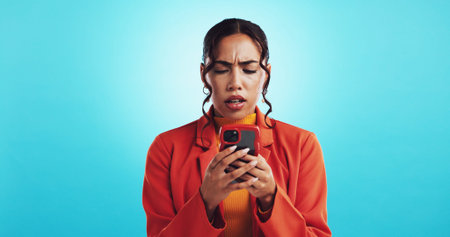 Woman, phone and confused with app in studio, stress and notification for web scam by blue...