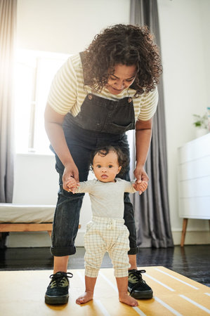Mother, baby and learning to walk holding hands in home, education and bonding. Care, development...