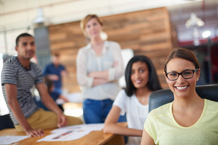 Confident, designers or portrait of happy woman in meeting, development or discussion in office. Leadership, startup or creative people in collaboration for planning growth, teamwork or businessの写真素材