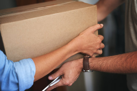 Hands, package and person for delivery at house with ecommerce, dropshipping and exchange service. People, giving and box with logistics product of distribution courier, freight safety and front doorの写真素材