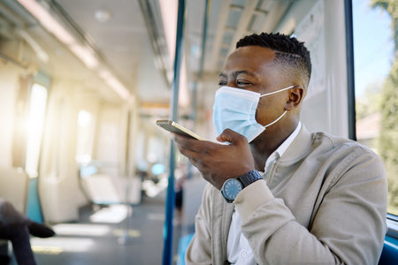 Black man, phone and face mask for train travel with ppe compliance, metro safety and transport...