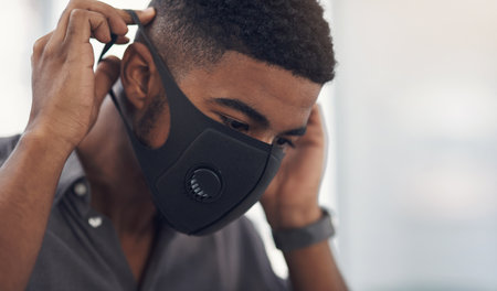 Office, businessman and health with face mask for protection, wellness and safety against influenza. Awareness, worker and designer with cover to prevent virus, bacteria and compliance for pandemicの写真素材