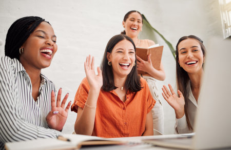 Women, team and video call with laptop in modern office for wave, smile or diversity at media company. Business people, startup and computer in meeting, contact or excited for deal at creative agencyの写真素材