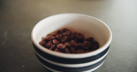 Kitchen counter, bowl and cereal in morning for breakfast, nutrition and fiber for meal on table....