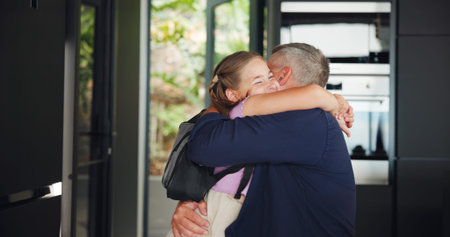 Father, child and hug for school in home with with greeting, education support or morning routine. Family, man or girl with backpack for goodbye embrace, affection and leaving with connection or loveの写真素材