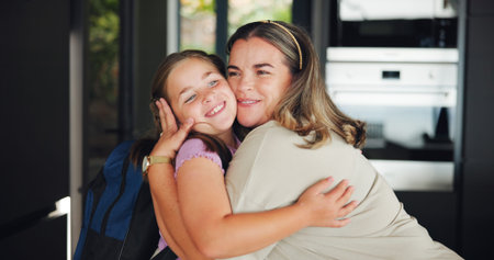 Mother, girl and hug for school in home with goodbye, affection and education support. Morning routine, woman or kid with backpack for greeting, embrace and leaving with learning preparation or loveの写真素材