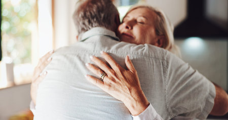 Senior couple, hug and bonding in home, love and enjoying reunion with happy wife in kitchen....