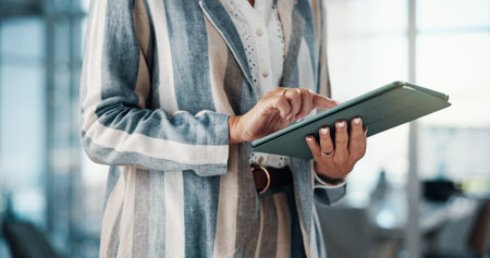 Agency, hands and tablet with editor person in office for planning, publishing or review closeup. App, business and scrolling with publisher proofreading article at editing job for online magazineの写真素材