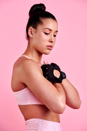 Fitness, mma and health with woman in studio for wellness, boxing and challenge. Exercise, workout and training with person on pink background for martial arts, performance and sports athleteの写真素材