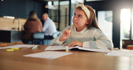 Thinking, homework and child in home with test for remote learning, education and lesson. School, studying and young girl with assessment, quiz and assignment for knowledge, exam and ideas for answerの写真素材