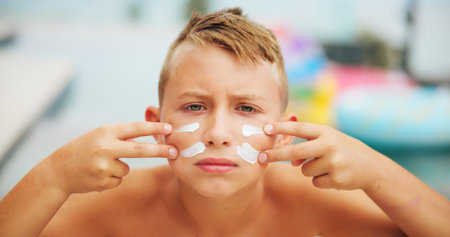 Sunscreen, face and portrait of boy at swimming pool for uv rays protection, spf cream and summer...