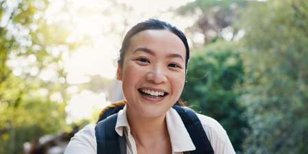 Portrait, Asian woman and hiking in forest of backpacking, travel adventure and fitness in...