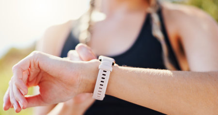 Exercise, hands and woman check smart watch outdoor for performance tracking, speed monitor and training results. Runner, athlete and sports app for fitness progress, heart rate and calories countの写真素材