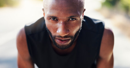 Tired, black man and rest with portrait of fitness break, exercise recovery and running workout. Male athlete, fatigue and relaxing in city with sports training, marathon practice and cardio wellnessの写真素材