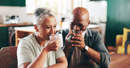 House, coffee and senior couple with love, romance and bonding together with relationship. Valentines day, old man and mature woman in living room, cappuccino and herbal tea with marriage and smileの写真素材