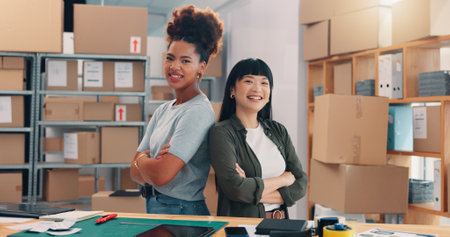 Business women, portrait and confidence with boxes in logistics for supply chain or distribution service. Female people, employees or distributors with smile or arms crossed for online shipping storeの写真素材