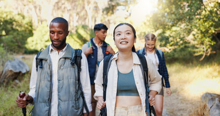 Group, friends and hiking in forest for backpacking, travel adventure and fitness in environment. People, walk and trekking journey to explore woods, nature survival or sightseeing for exercise hobbyの写真素材