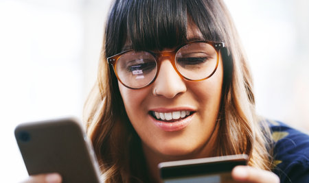 Online shopping, smile and woman with smartphone, card and browsing on website for digital product. Happy, ecommerce and credit for payment on app, customer and person with mobile for purchaseの写真素材