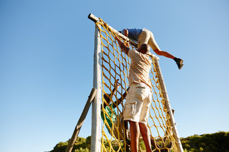 Fitness, outdoor or people climbing on obstacle for workout, endurance exercise or challenge. Military survival, mockup or men in physical activity for bootcamp training or strength assessmentの写真素材