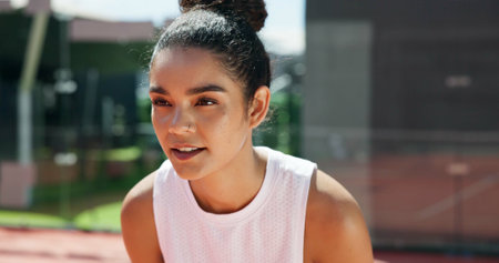 Woman, fitness or tennis with ready face for game, match or serve at padel court or turf. Female person, athlete or sport player with smile for playing, friendly competition or exercise challengeの写真素材