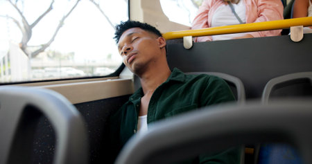 Sleeping, bus and travel with man, tired and commute with urban journey, relaxing and calm. Public transportation, passenger or guy in city, exhausted and dream with fatigue or resting in New Yorkの写真素材