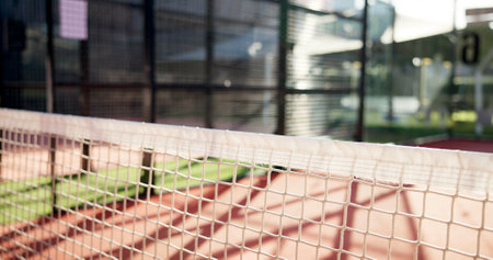 Tennis, sport and closeup of net on court for opponent barrier, fair play or competition match outdoor. Empty, padel field and mesh for game challenge, tournament setting or playing area for practiceの写真素材