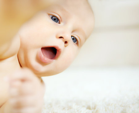 Curious, baby and explore on floor in home for sensory learning, motor development and wake up. Space, person and comfortable on carpet in living room for growth, playing and morning routine in houseの写真素材