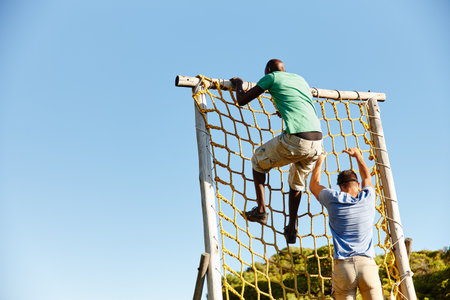 People, obstacle or climbing for outdoor workout, exercise or bootcamp challenge with space. Military survival, net or men in physical activity for tactical training, fitness or strength assessmentの写真素材