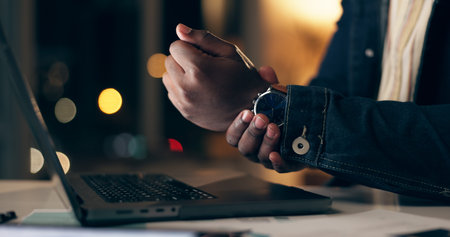 Black man, laptop and wrist pain at night in office with overtime or workaholic with tendinitis or...