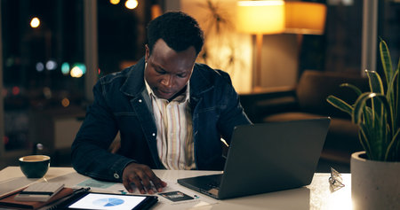African man, technology and typing at night in office for work, business and company. Investment...