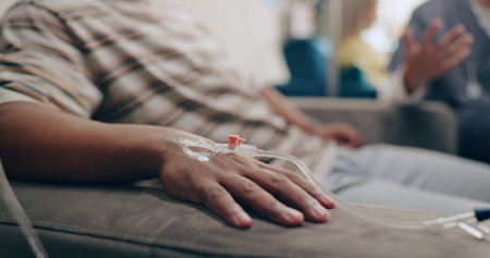 Nurse, IV needle and hands at a hospital with vaccine and healthcare infusion with virus. Medicine,...