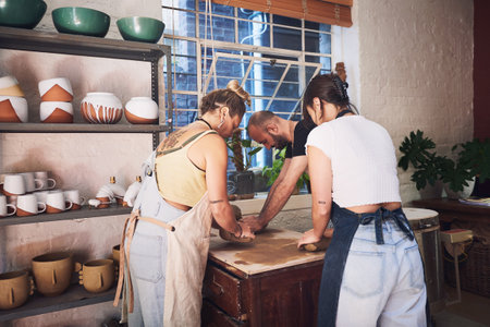 Talent, entrepreneur and people with clay, pottery and artistic for handmade product, creative and teamwork. Collaboration, ceramic and group with skills for production, kneading and small businessの写真素材