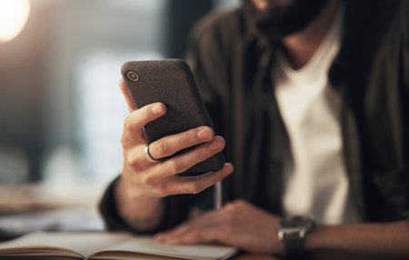 Phone, research and hands with business man in office for planning, typing and client feedback. Communication, night and email with closeup of person in agency for web design, virtual advisor or appの写真素材