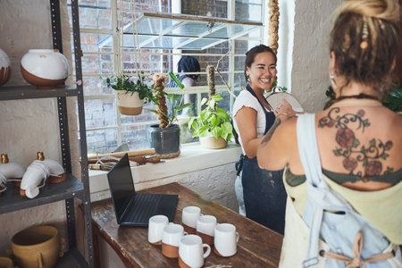 Artist, clay and happy women in pottery workshop for manufacturing or production together. Creative, design and ceramics with small business store owners in boutique for retail sale of merchandiseの写真素材