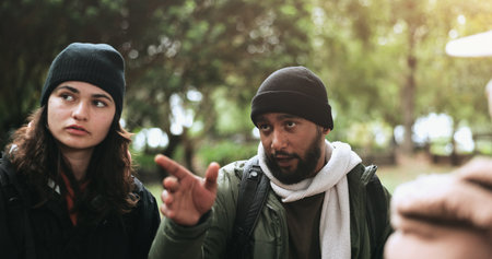 Hiking, couple and travel with view from trekking on an adventure and journey outdoor. Backpack, forest and woods with workout on a vacation with talk from holiday and fitness on walk in natureの写真素材