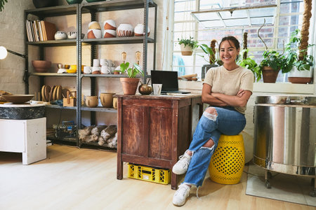 Pottery, workshop and woman with arms crossed in portrait for manufacturing startup, creative studio...
