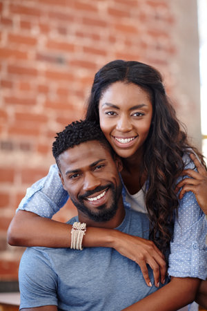 Black couple, hug and safety in happy portrait, weekend date and together for romantic partnership. Embrace, people and trust commitment in relationship, connect and support boyfriend with careの写真素材
