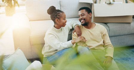 African couple, floor and holding hands in new house, moving and pride with smile for real estate...
