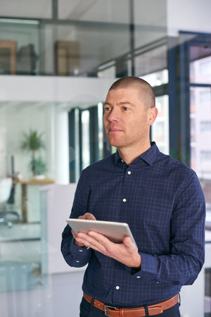 Creative, tablet and thinking with business man in office for future, planning or research. App,...
