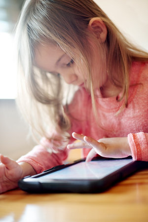 Kid, student and typing on tablet in classroom for streaming lesson, elearning website and drawing....
