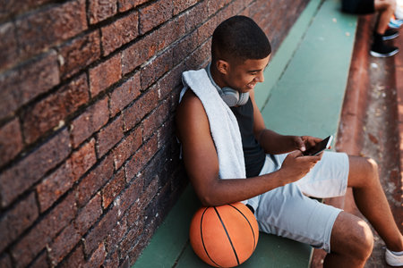 Court, basketball player and man with phone screen for social media, connection and watch video. Sports, happy person and athlete with mobile app for fitness tips, advice and scroll outdoor by aboveの写真素材
