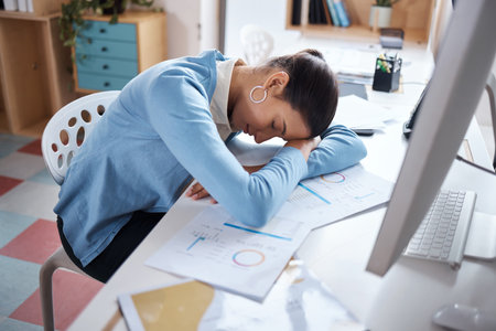 Office, businesswoman and sleeping by computer for burnout, tired and overworked in corporate company. Nap, female person and accountant with exhaustion for documents, auditing and fatigue on deskの写真素材